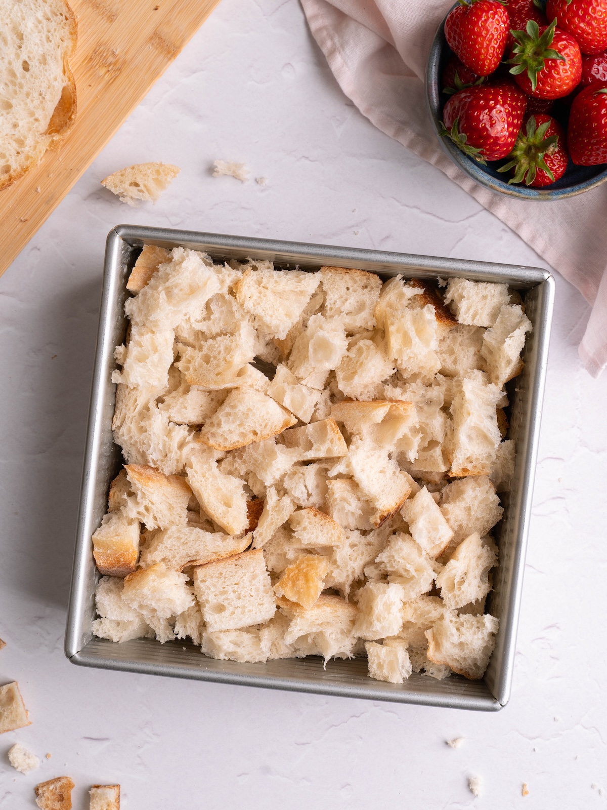Sourdough bread cut into cubes in a baking dish