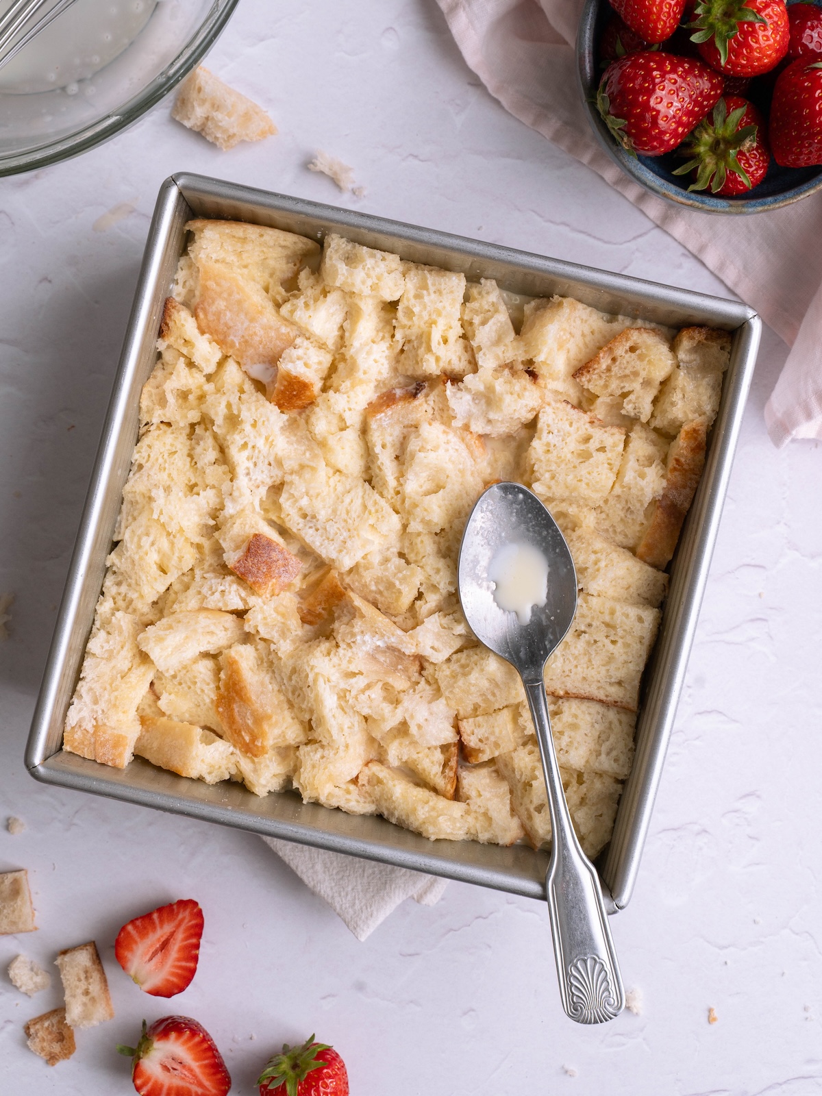 Cubes of sourdough bread soaking in custard