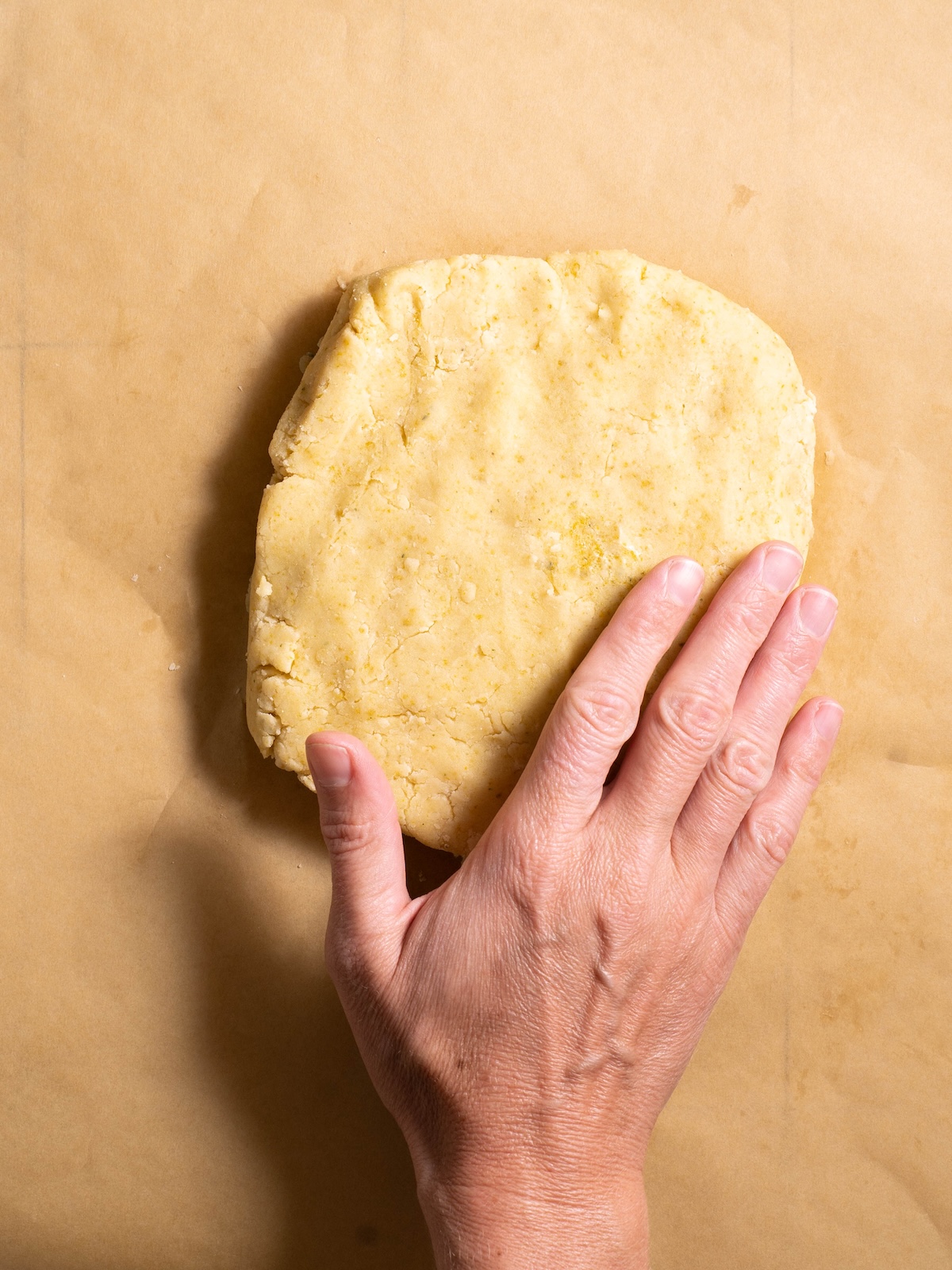 Patting dandelion cookie dough into a disc