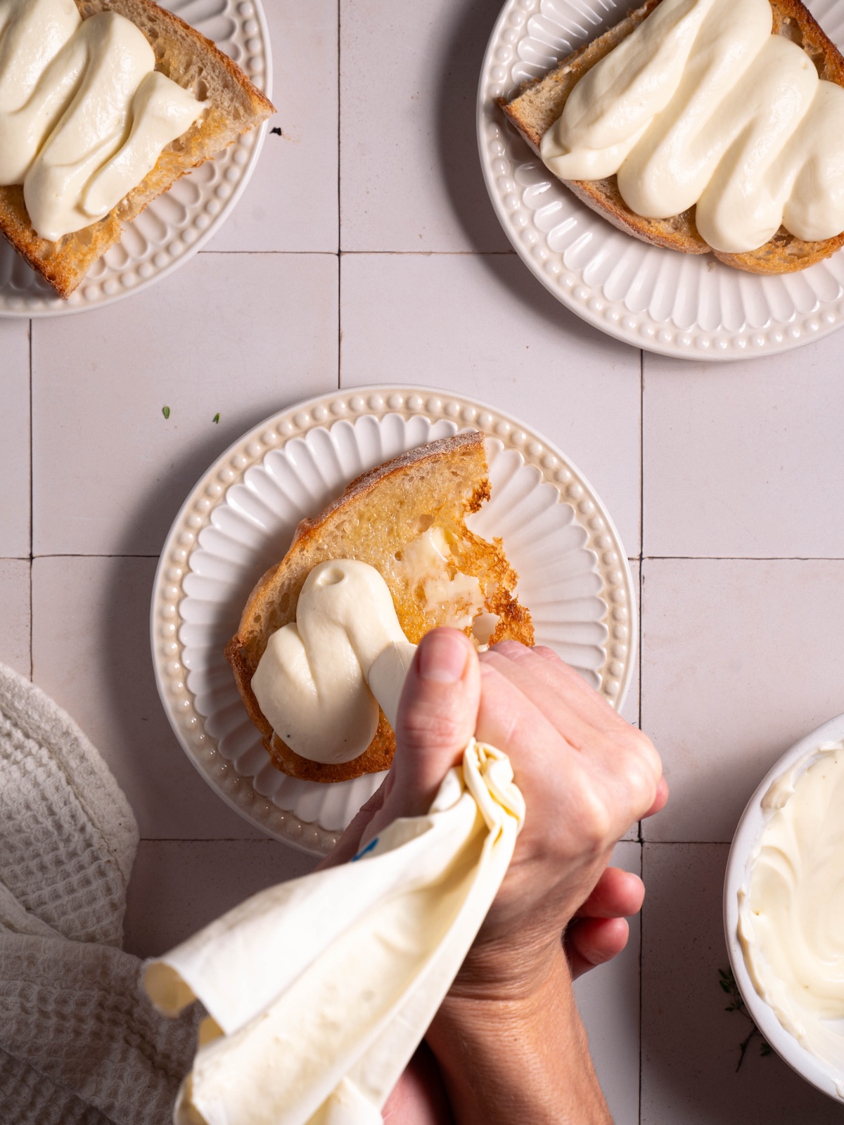 Piping whipped ricotta onto sourdough toast