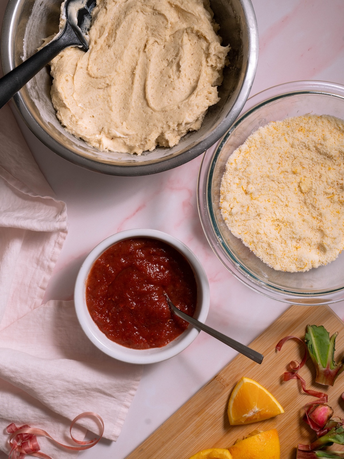 Component for a rhubarb crumble cake: cake batter, rhubarb compote, and streusel