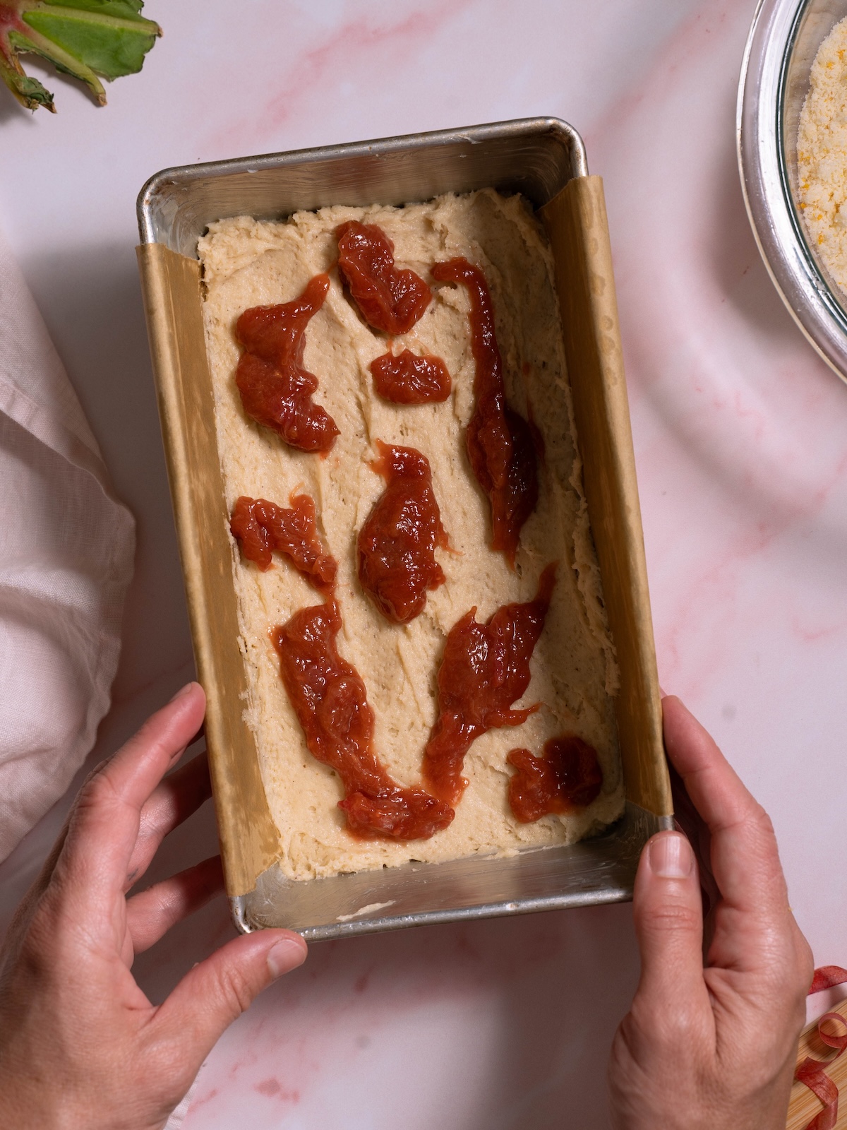 Rhubarb compote dolloped on top of cake batter