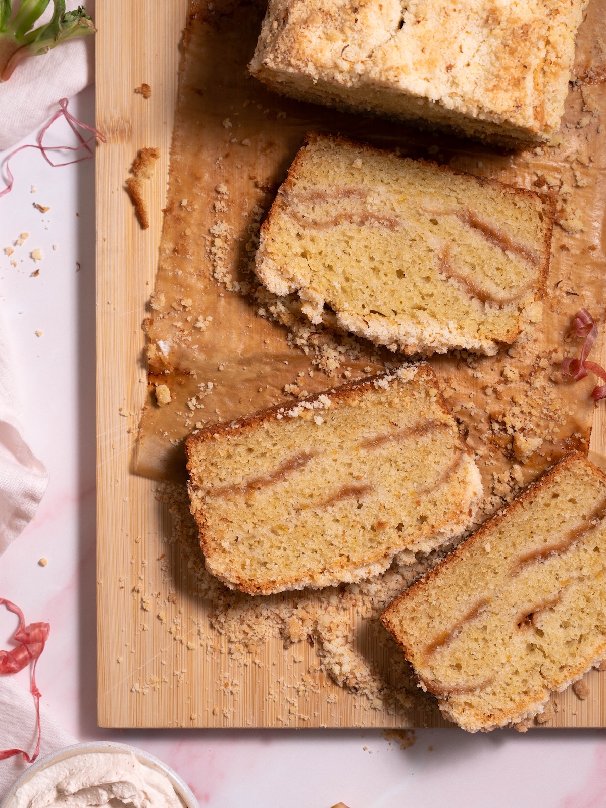 Slices of rhubarb cake with orange streusel on a cutting board