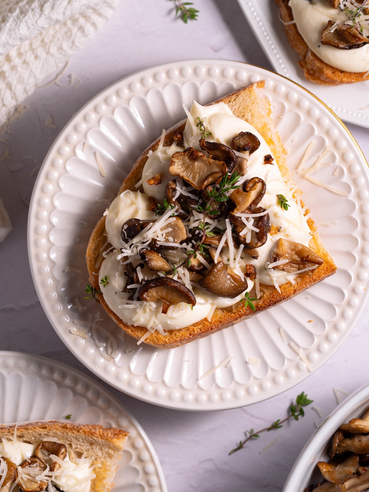 Creamy garlic mushroom toast on a small white plate