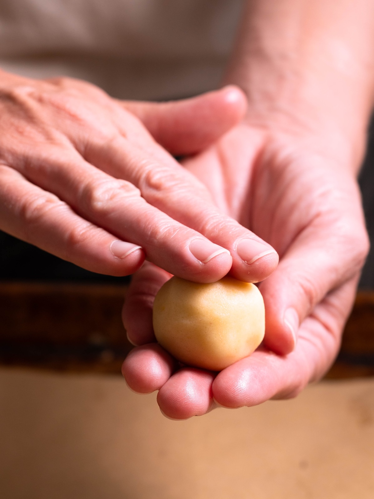 Rolling cookie dough between hands