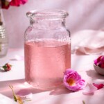 A jar filled with subtly pink homemade rose simple syrup