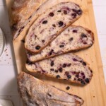 Slices of blueberry sourdough bread on a cutting board