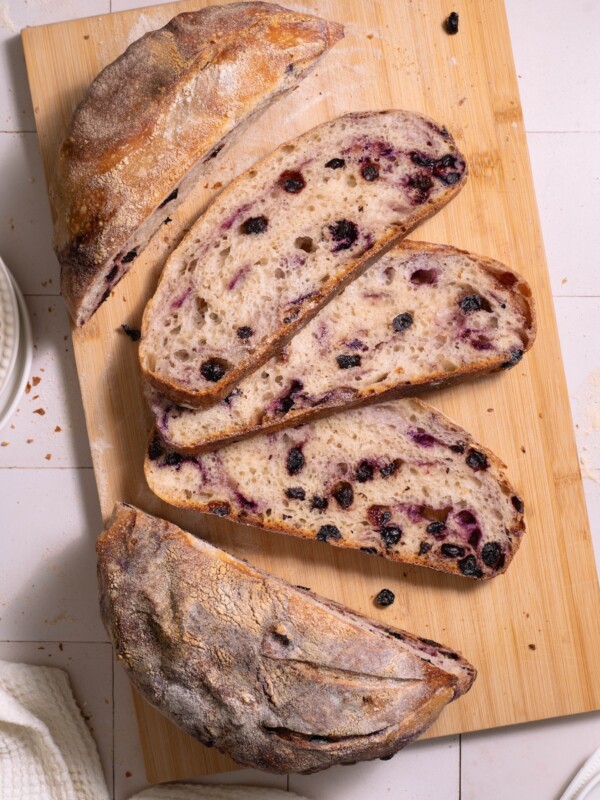 Slices of blueberry sourdough bread on a cutting board