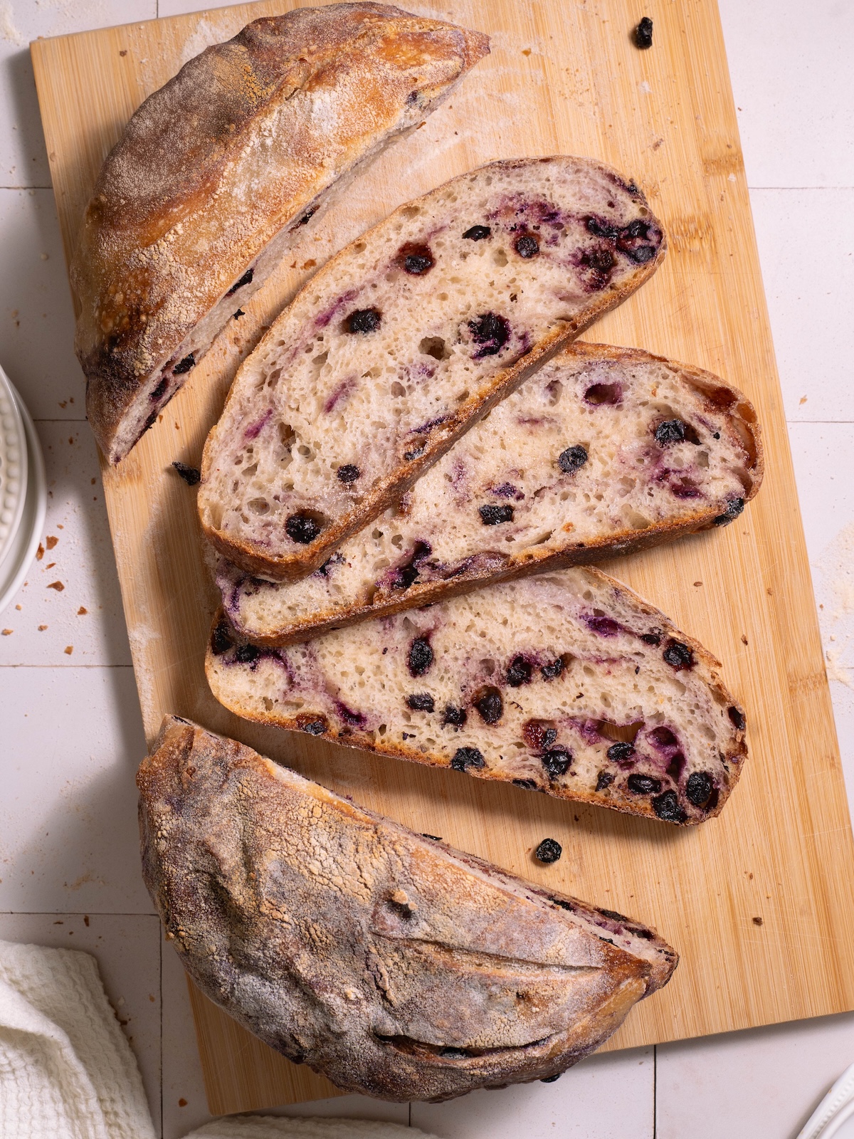 Slices of blueberry sourdough bread on a cutting board