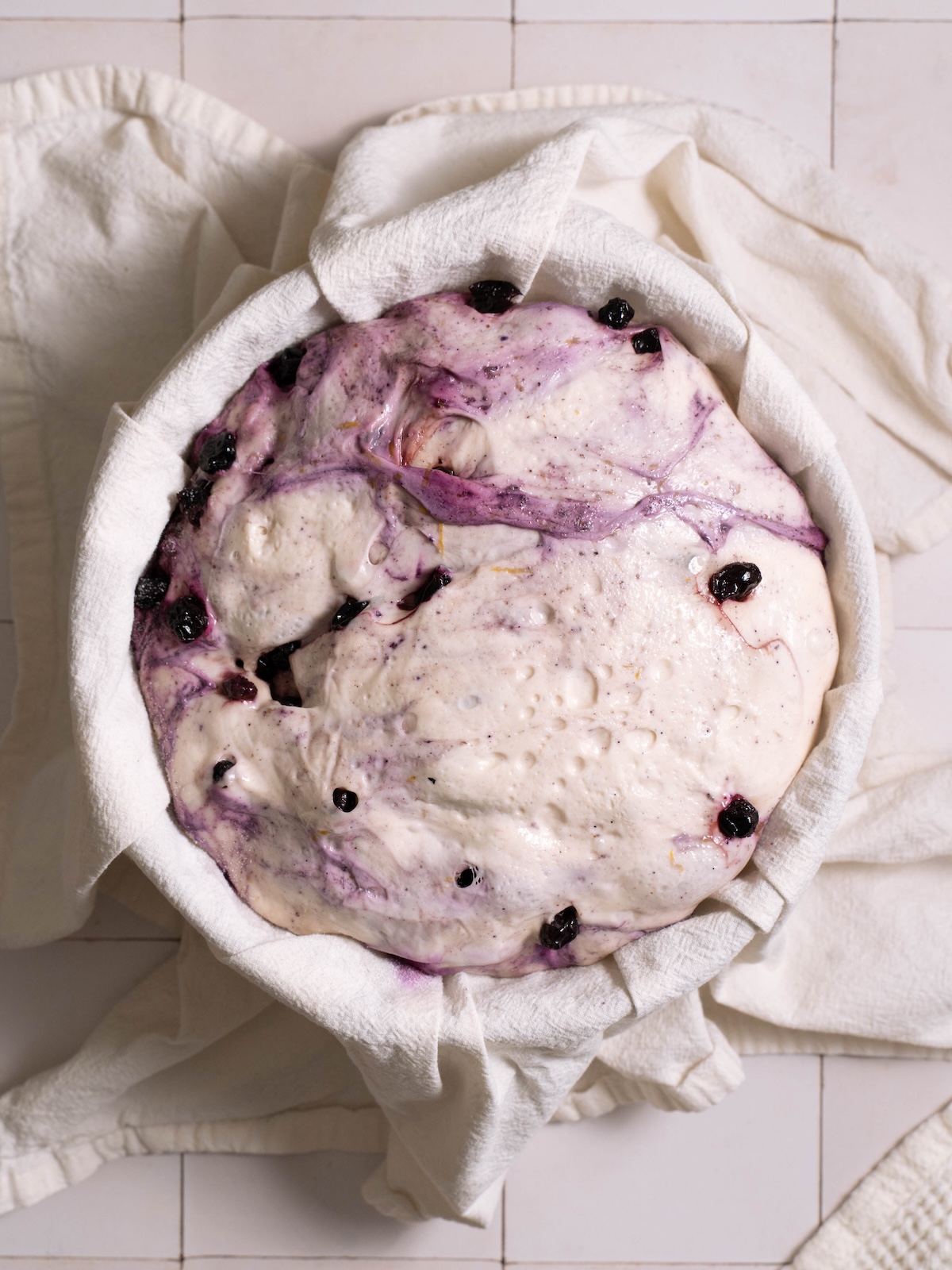 Lemon blueberry sourdough bread proofed in a bowl