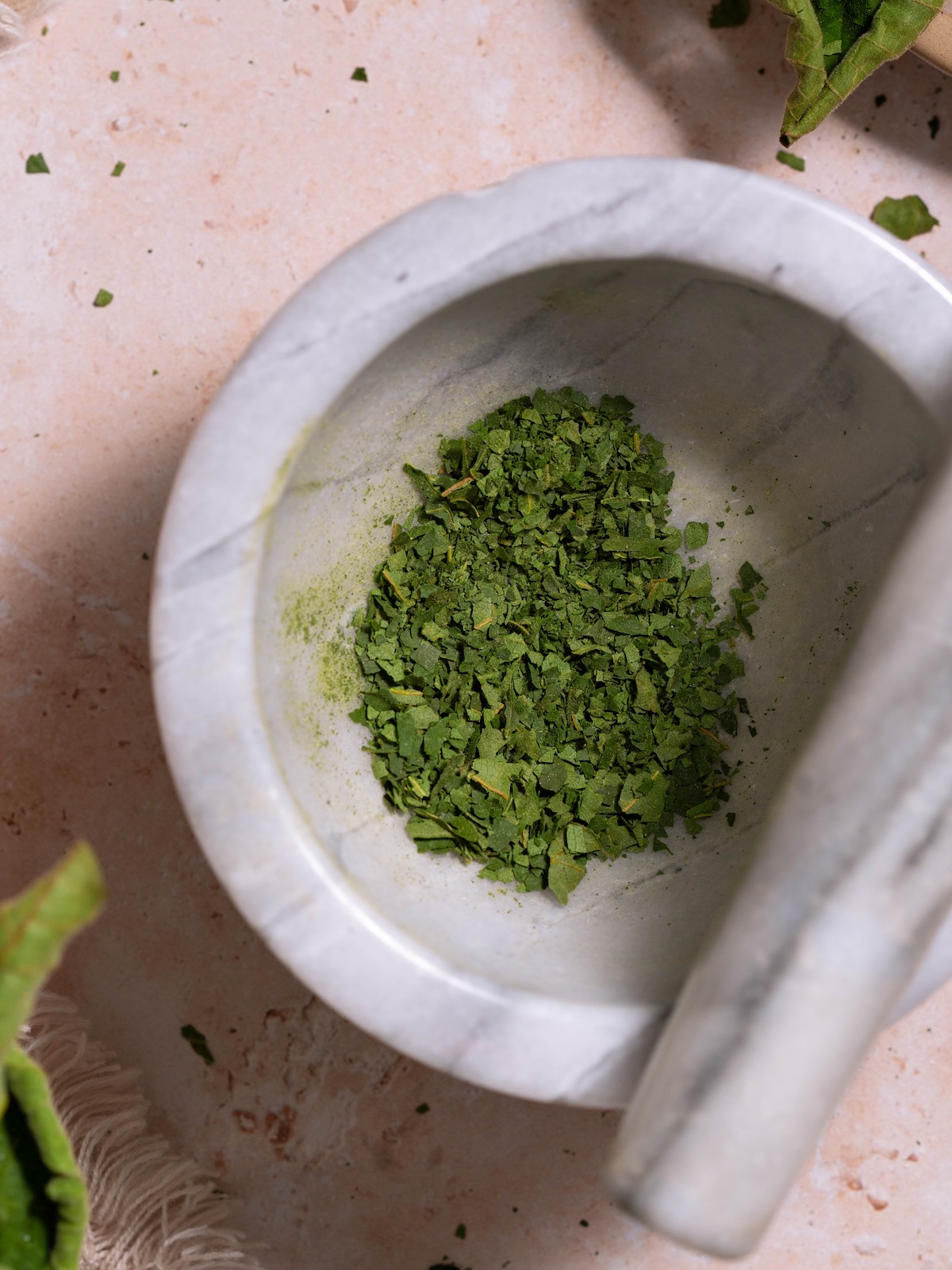 Toasted fig leaf powder in a mortar & pestle