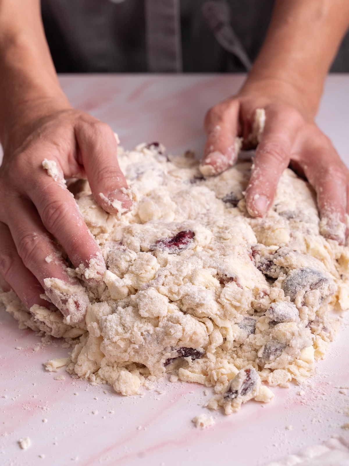 Kneading cherry scone dough with hands