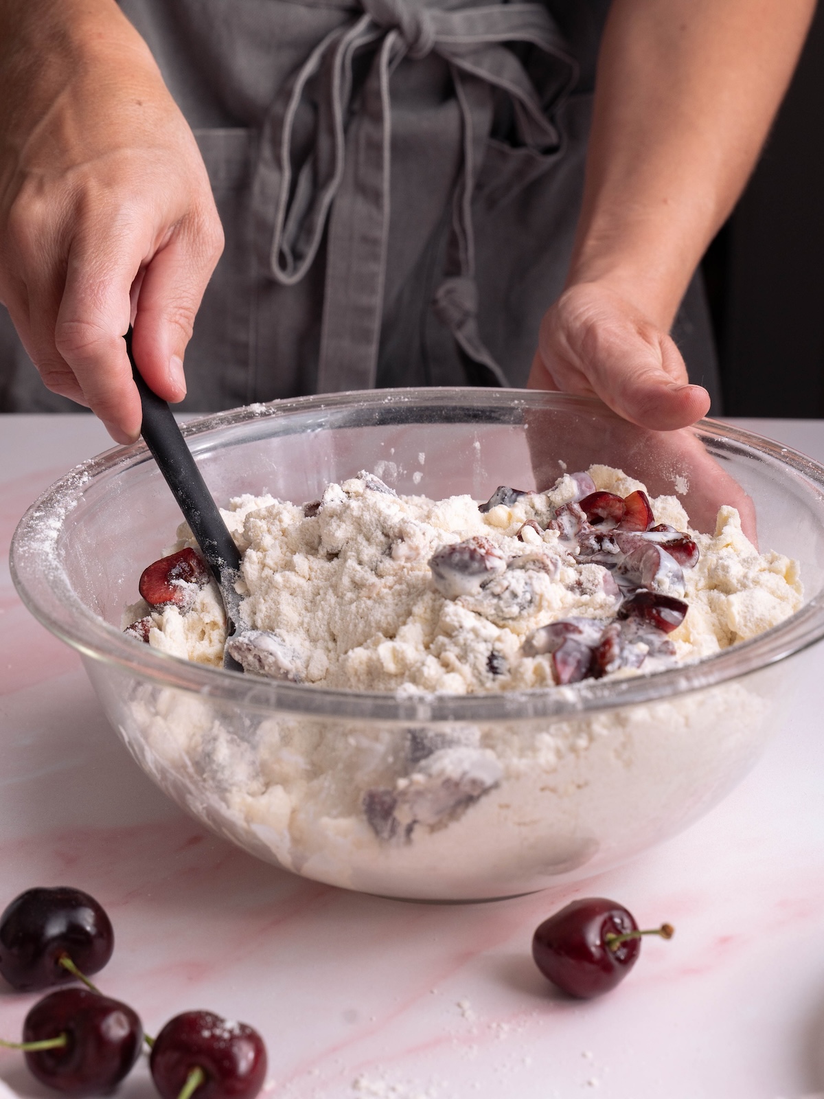 Mixing cherry scone dough in a bowl