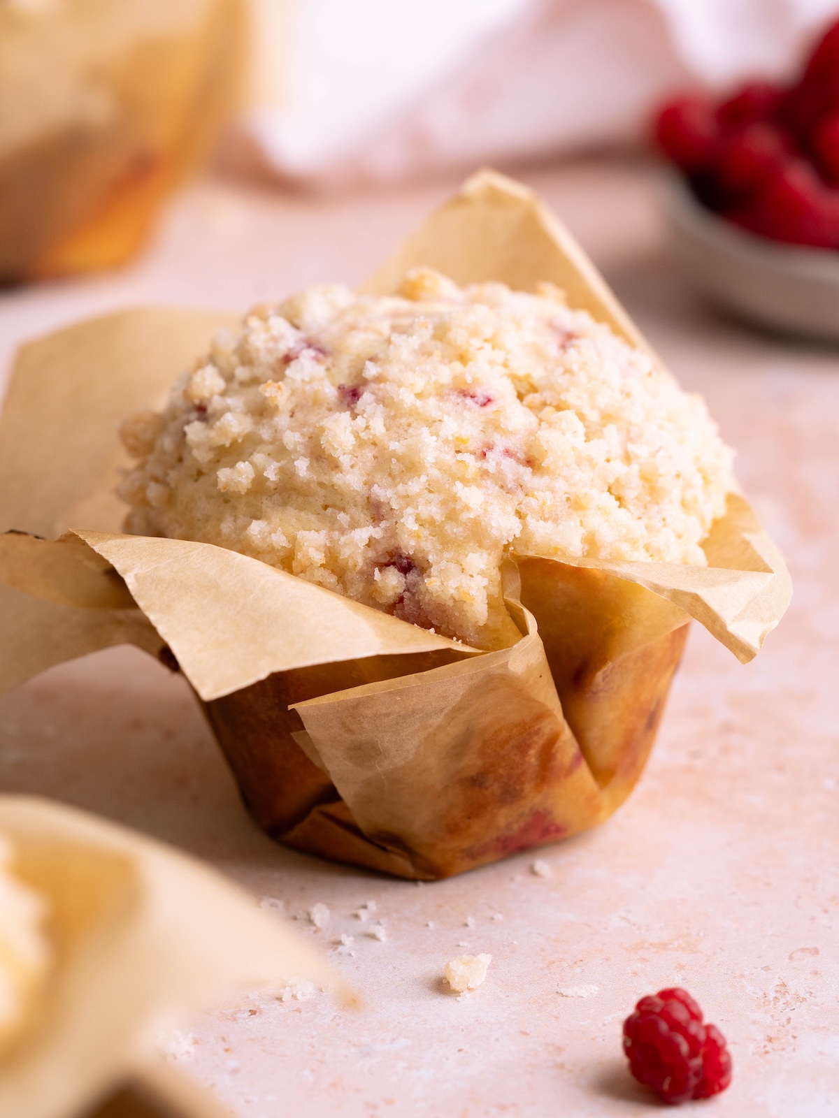 Raspberry streusel sourdough muffin baked in a homemade paper liner