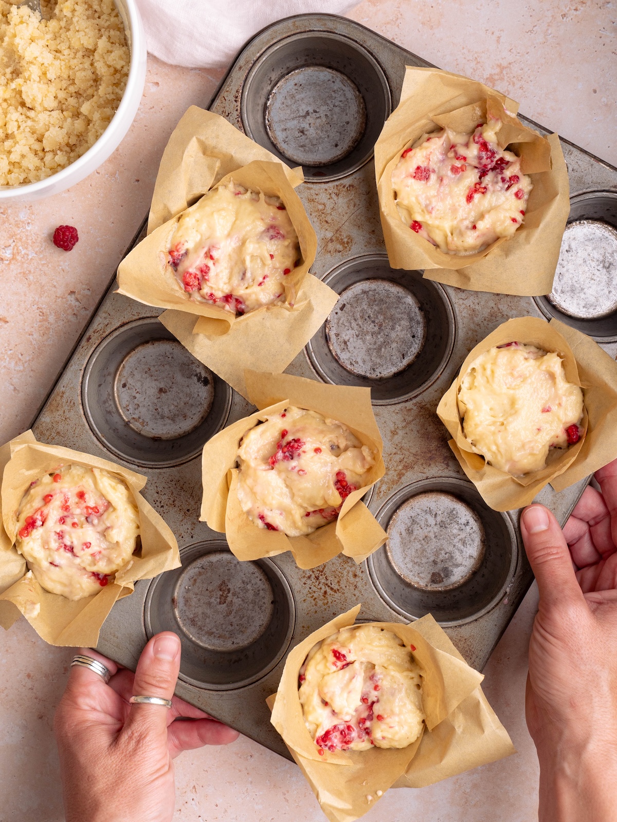 Sourdough raspberry muffin batter in homemade paper liners