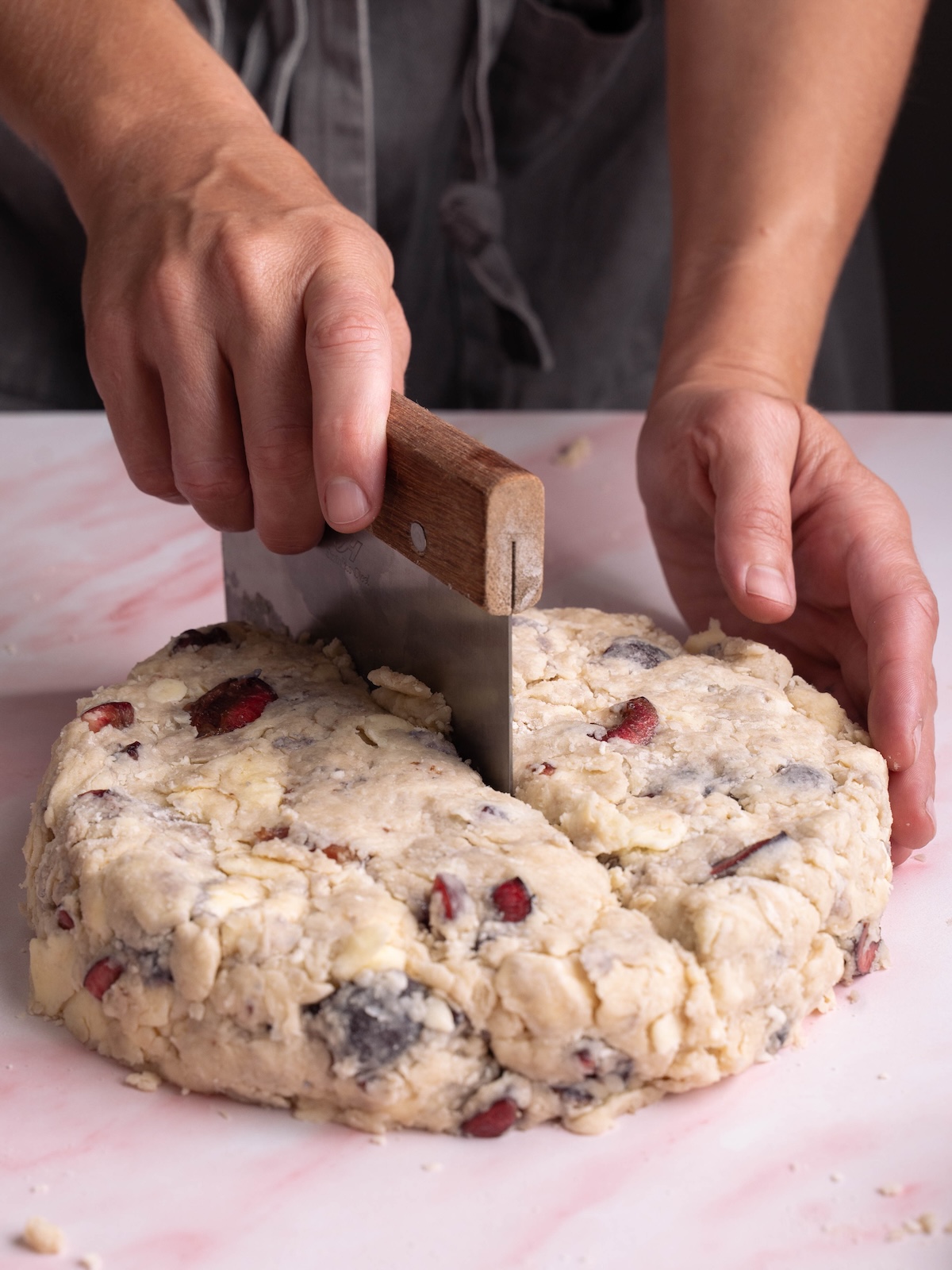 Slicing scone dough with a metal bench scraper