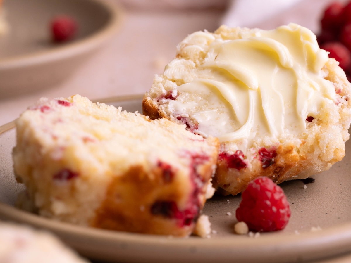 A raspberry muffin split in half and buttered
