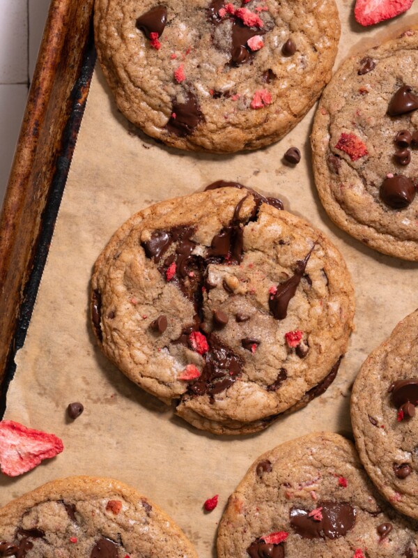Gooey strawberry chocolate chip cookies on a baking sheet