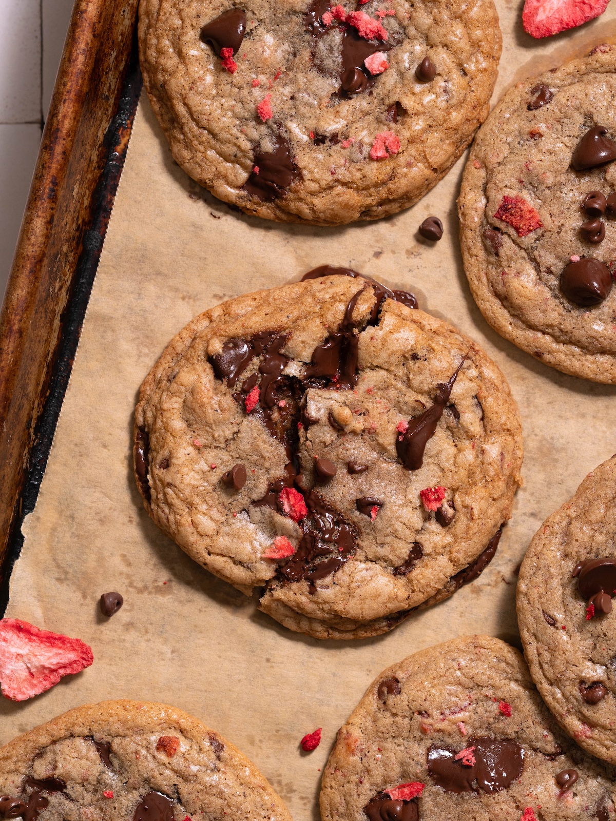 Gooey strawberry chocolate chip cookies on a baking sheet