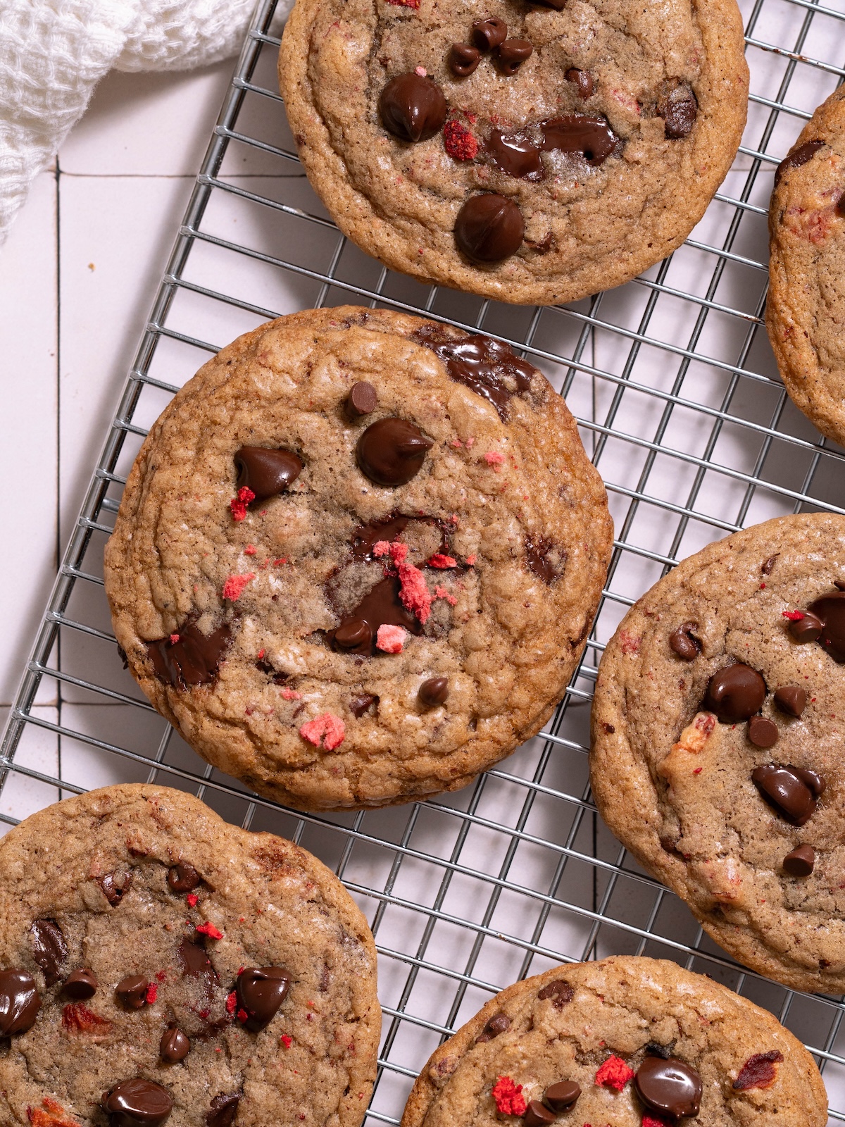 Strawberry chocolate chip cookies on a cooling rack