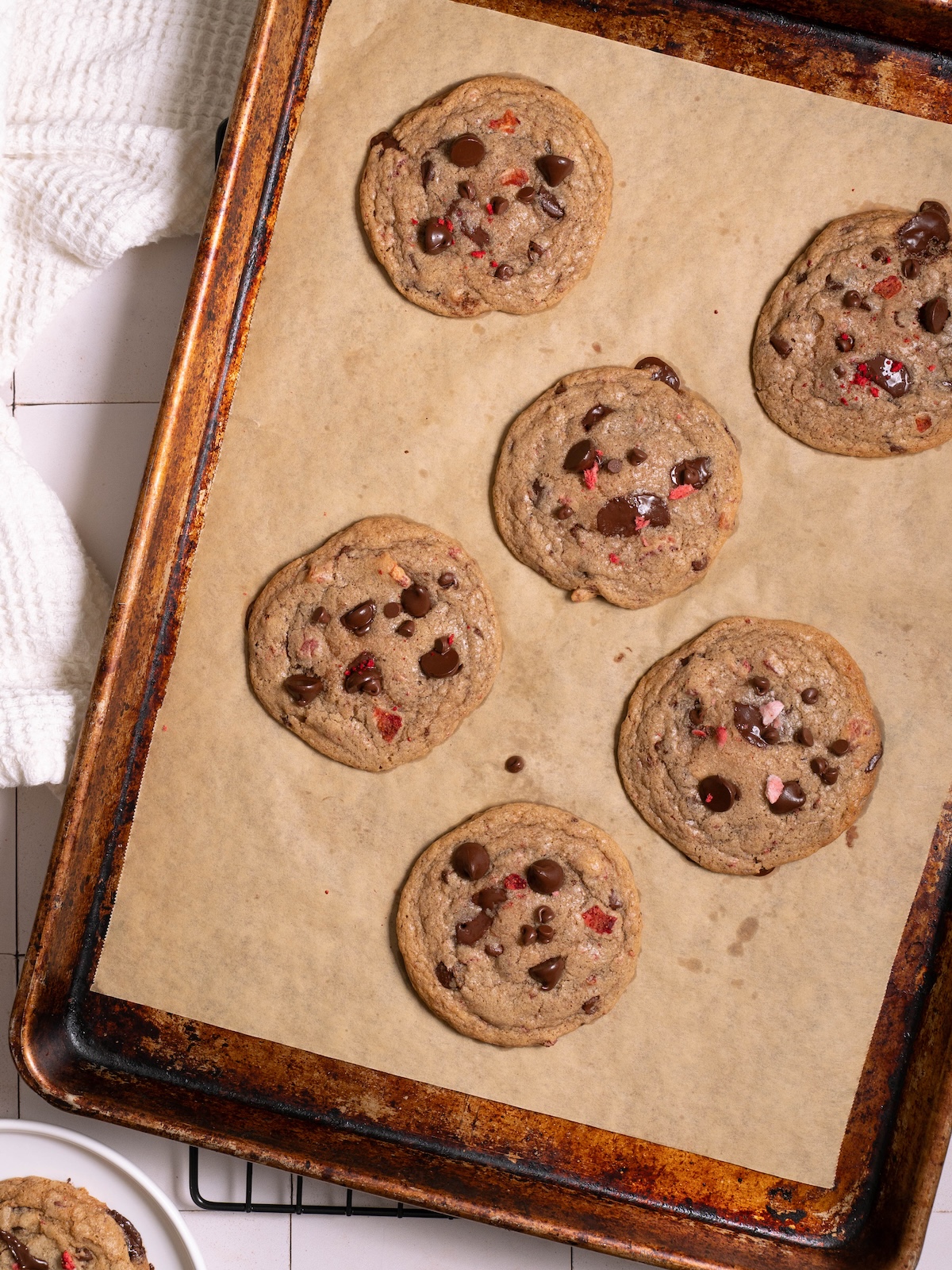 Chocolate and strawberry cookies freshly baked on a sheet pan