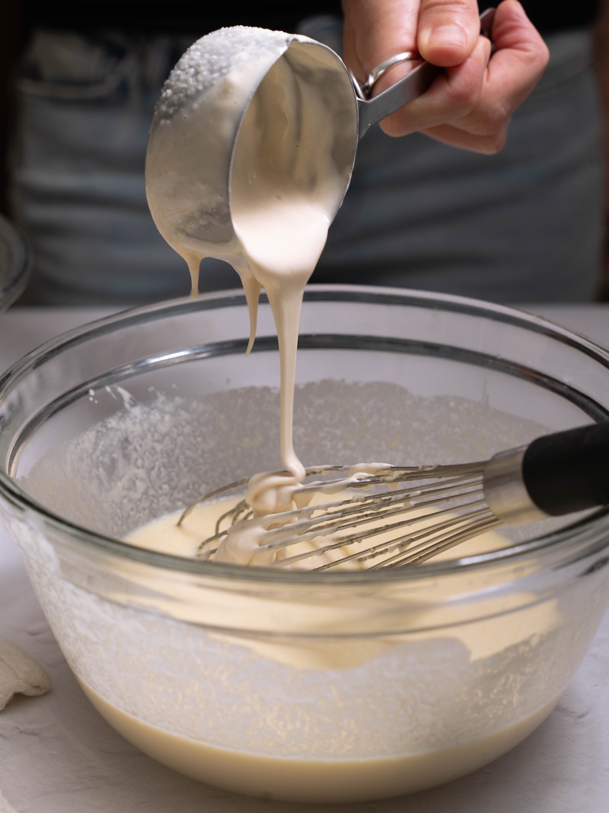 Pouring sourdough discard into a mixing bowl