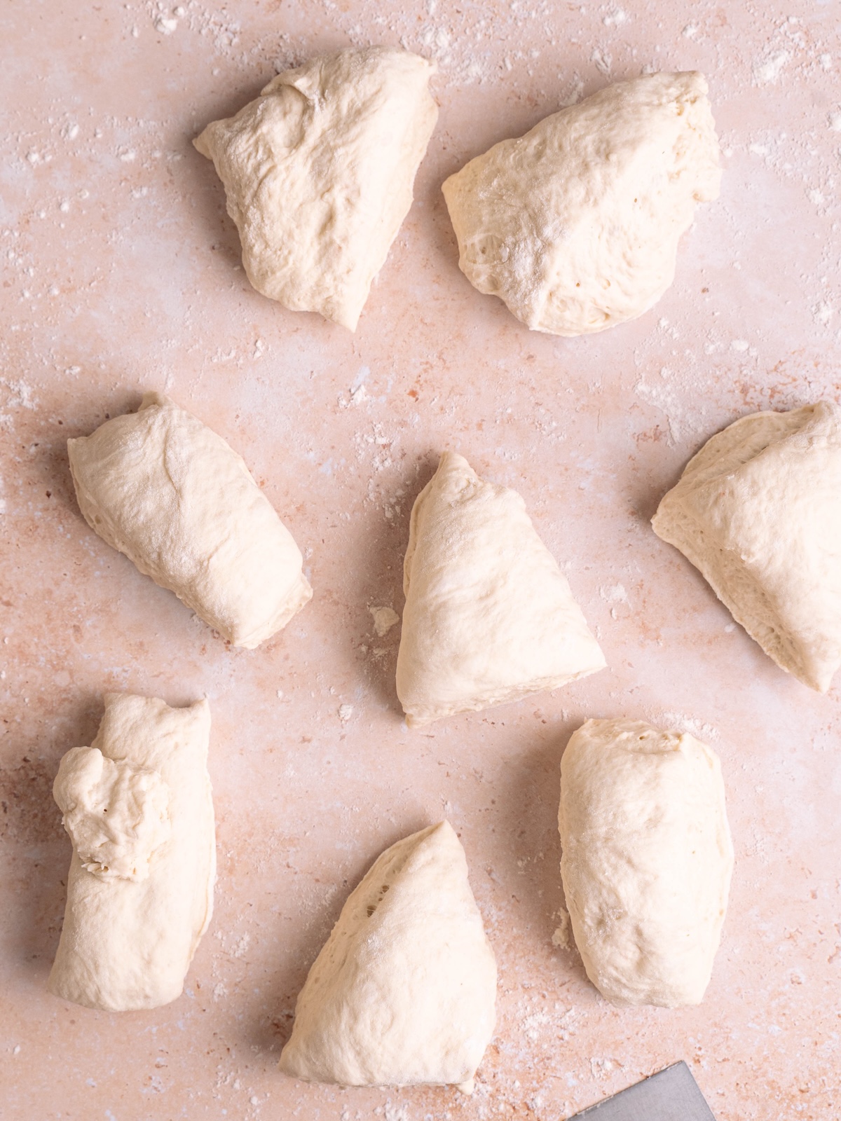8 pieces of dough on a floured work surface