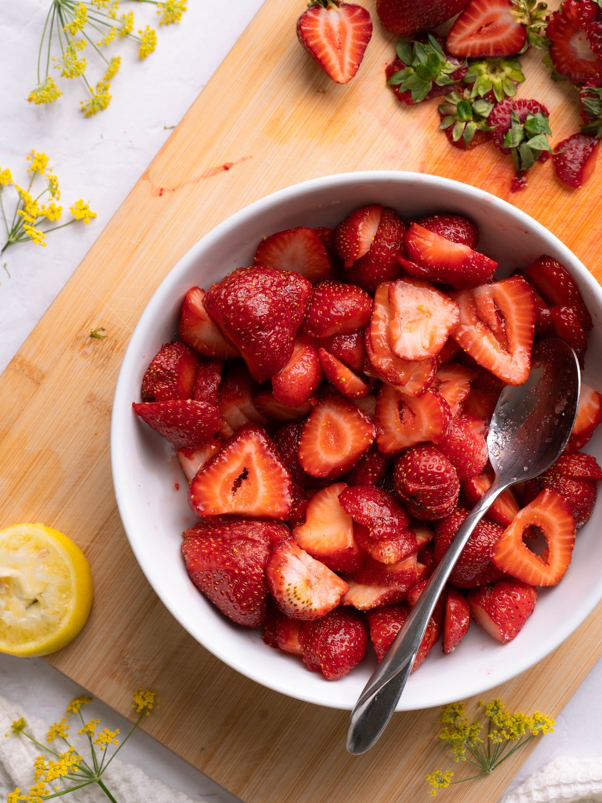 Sliced strawberries in a bowl with fennel pollen