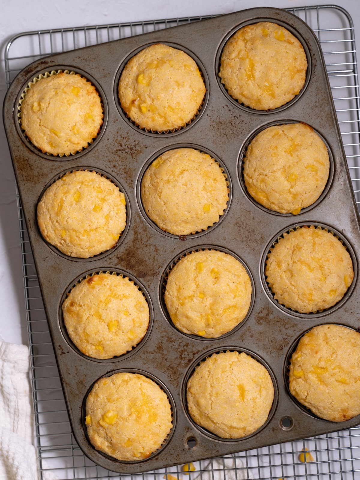 Sourdough corn muffins, freshly baked in a muffin tin