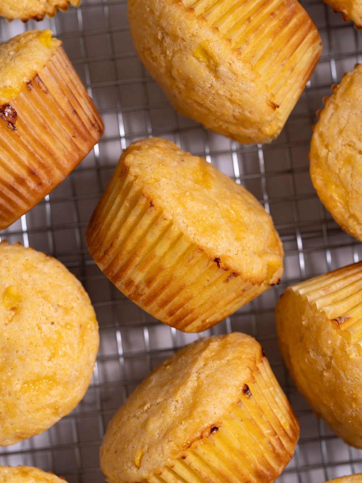 Sourdough discard corn muffins on a cooling rack