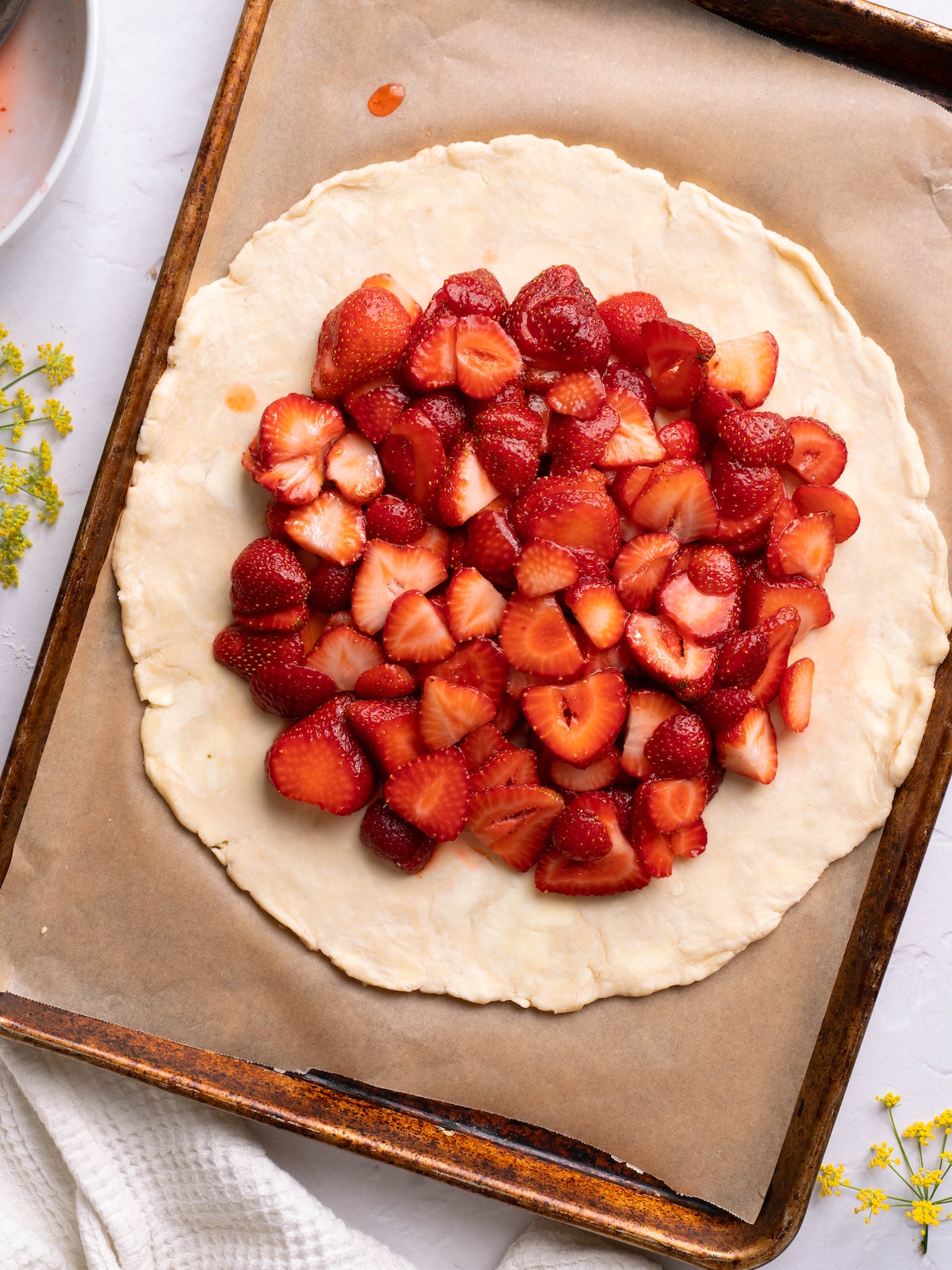 Macerated strawberries on a circle of pie dough