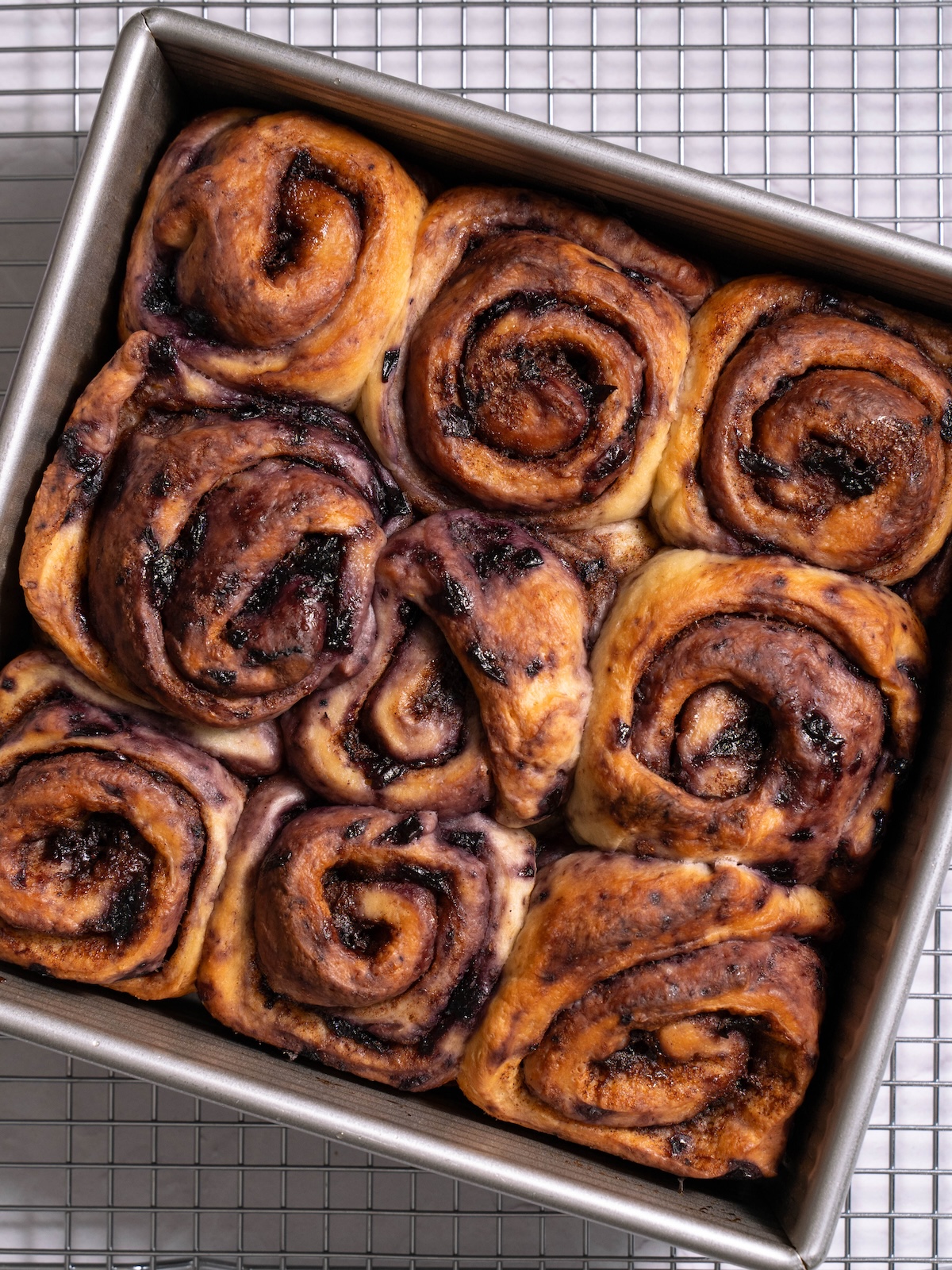 Freshly baked cinnamon rolls filled with blueberry jam filling