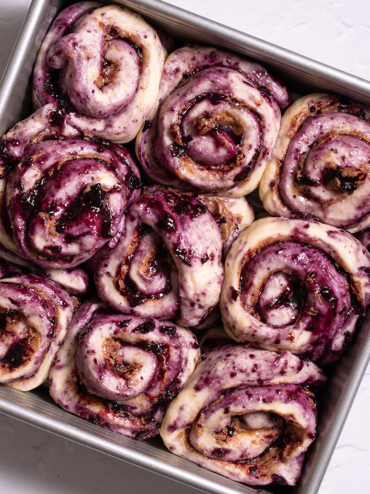 Blueberry cinnamon rolls in a pan after proofing