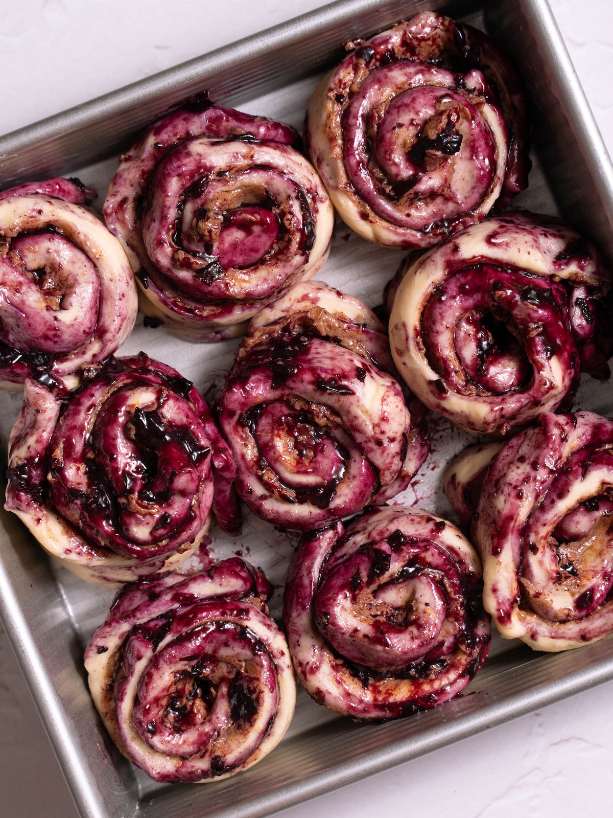 Blueberry cinnamon rolls in a pan before proofing