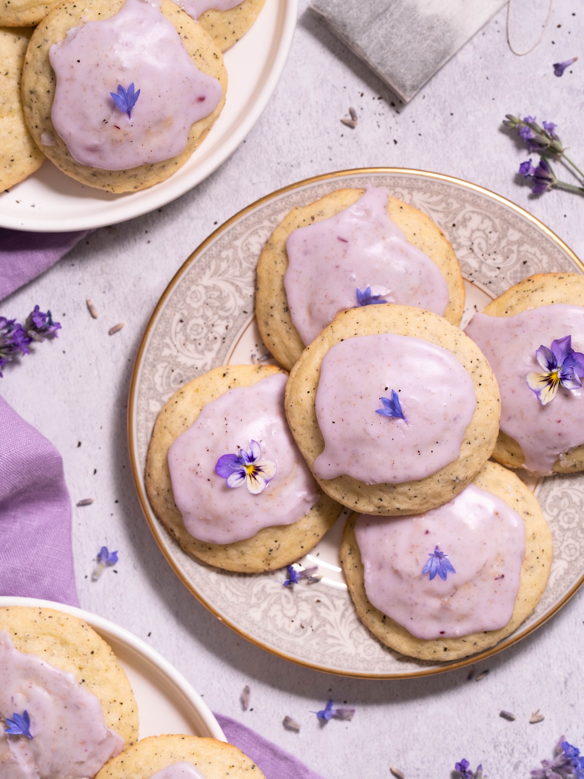 Lavender earl grey cookies with light purple glaze, on little cookie plates