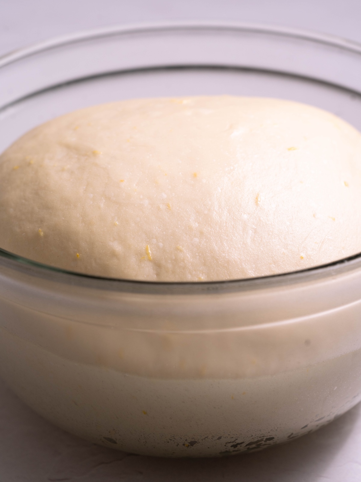 Lemony sweet roll dough, proofed in a bowl