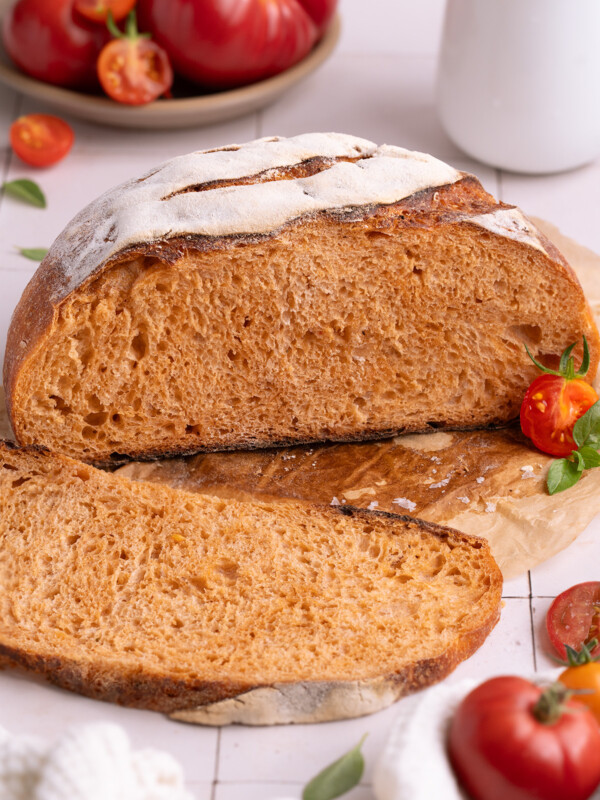 A loaf of roasted tomato basil sourdough bread, sliced open