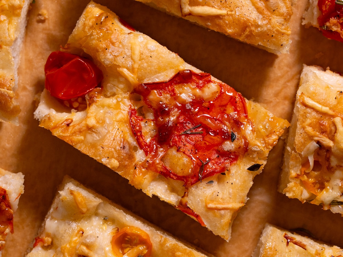 A piece of homemade tomato parmesan focaccia