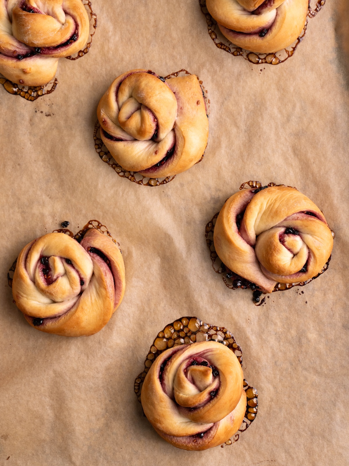 Spiraled elderberry buns on a baking sheet