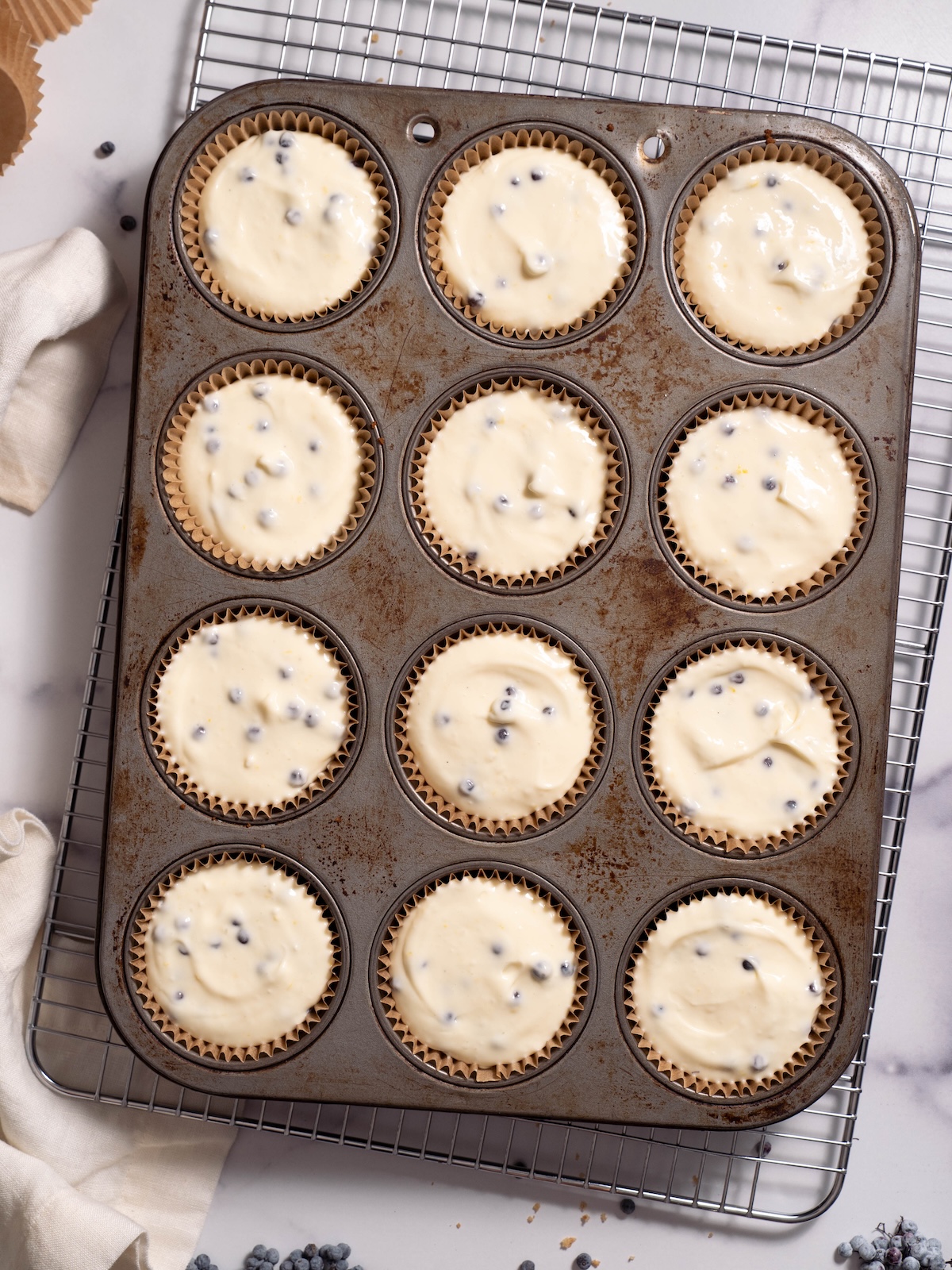 Elderberry-filled mini cheesecakes before baking