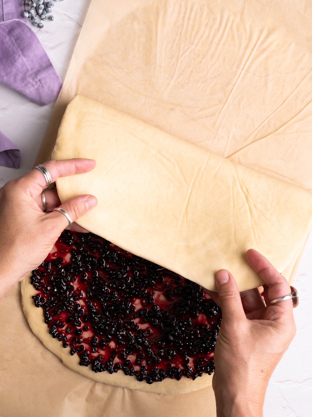 Folding dough over jam
