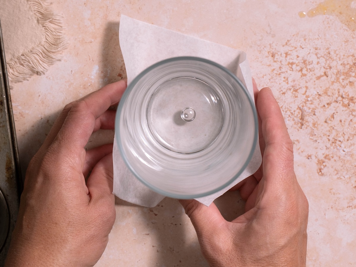Folding parchment paper around a drinking glass