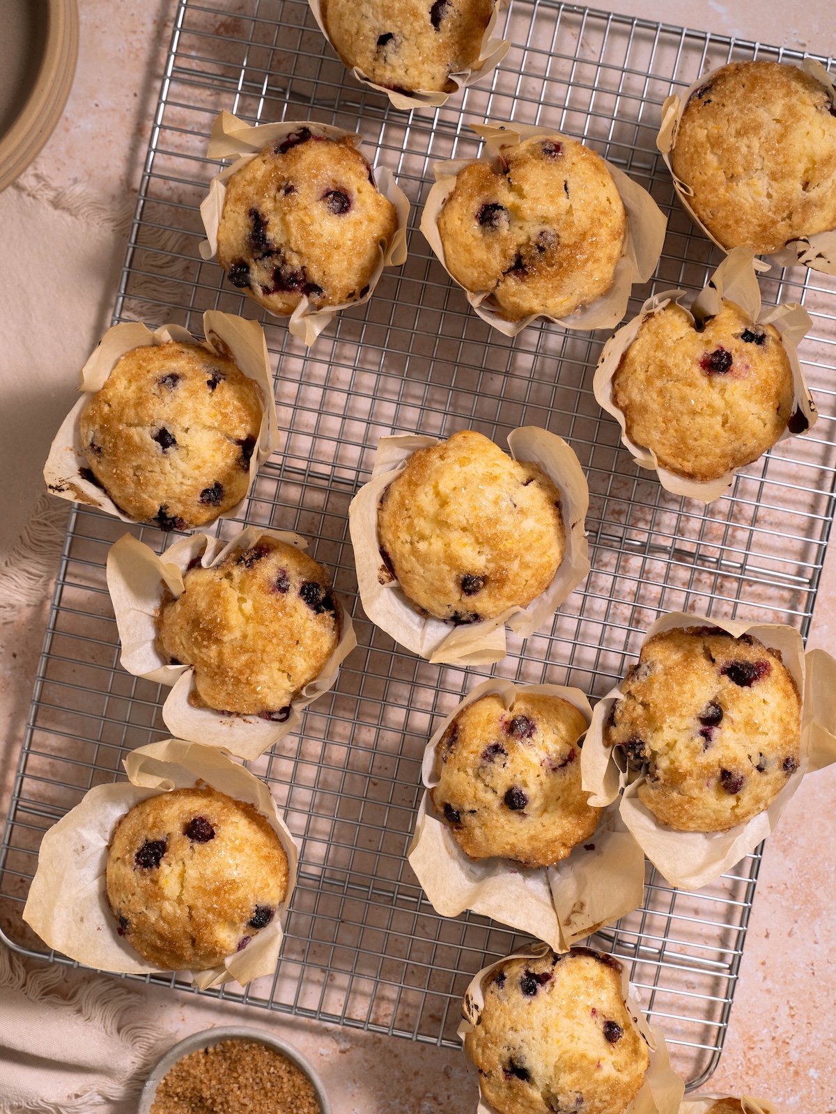 Sourdough discard huckleberry muffins cooling on a cooling rack