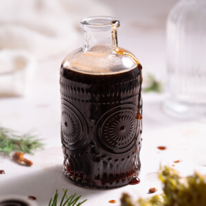 Dark syrup made with Douglas fir pine cones in a glass jar