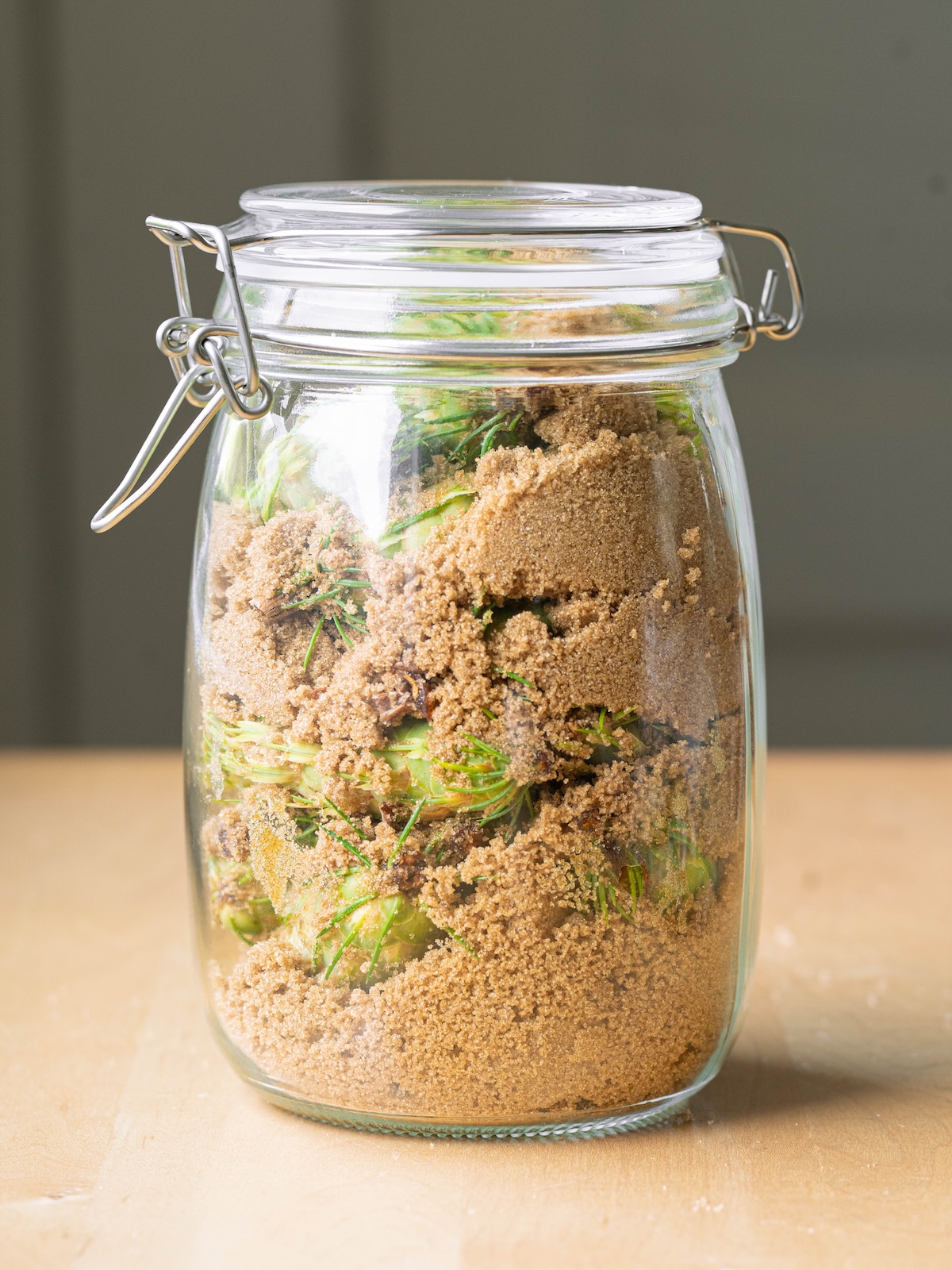 Brown sugar and Douglas fir pine cones layered in a jar