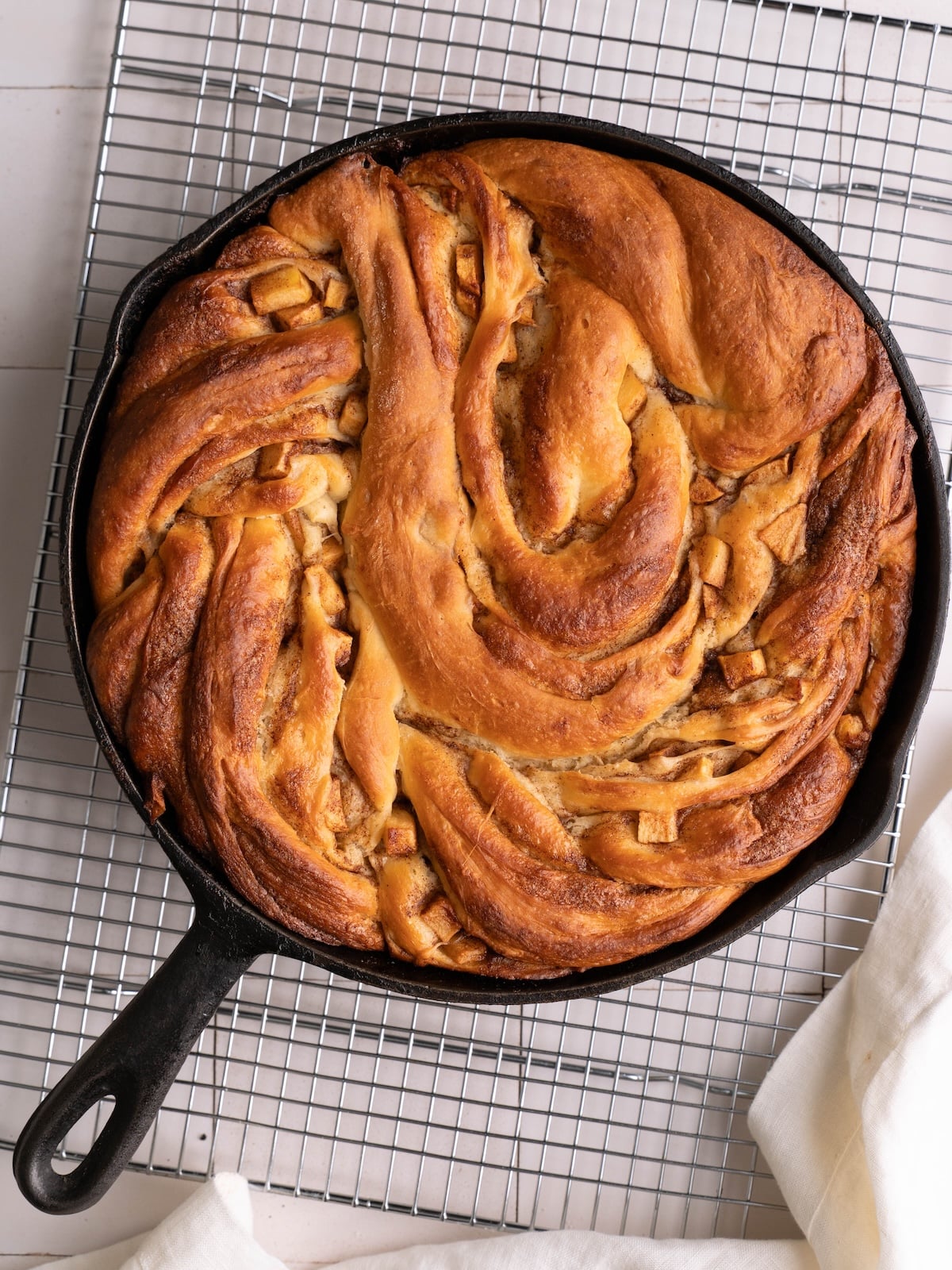 Freshly baked apple cinnamon twist in a cast iron pan