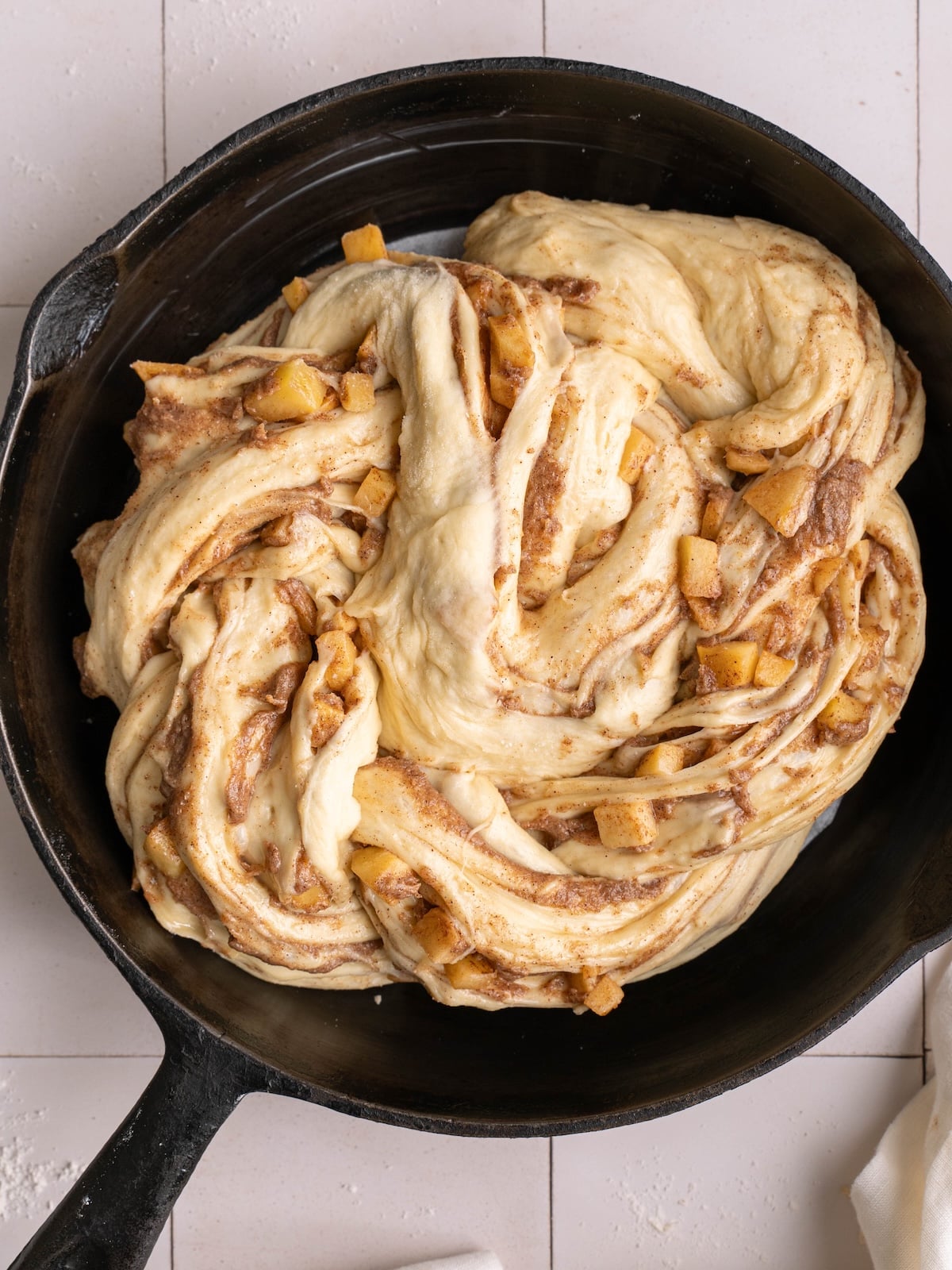 Giant apple cinnamon roll, shaped in a pan and ready to proof