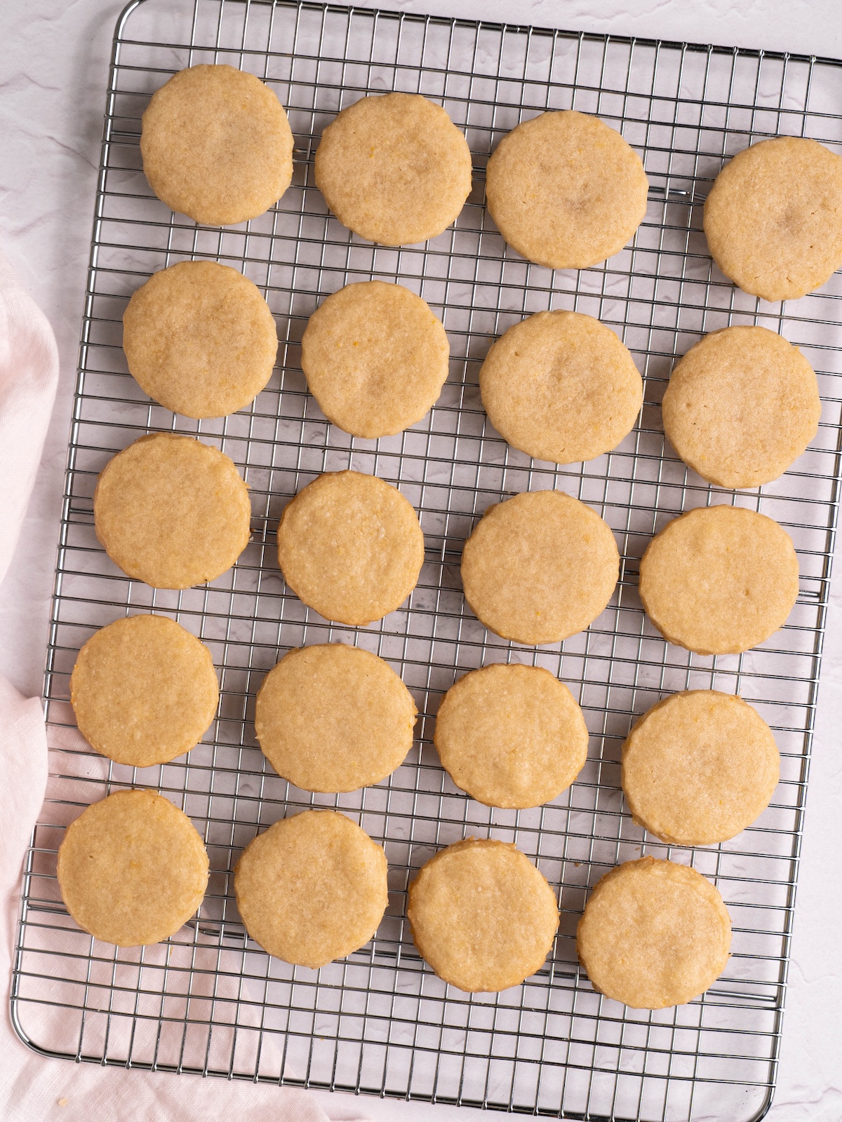 Little round shortbread cookies cooling on a rack
