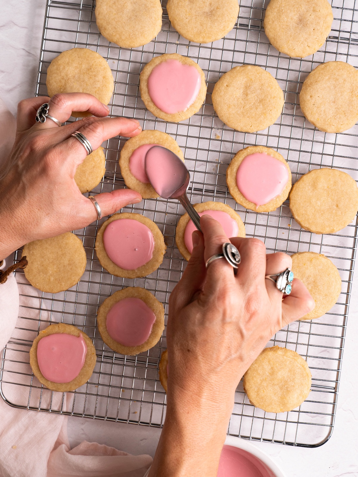 Spooning hawthorn glaze onto shortbread cookies