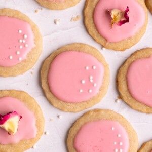 Lemon shortbread cookies covered in pink hawthorn berry glaze